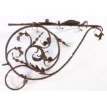 An early 18th century decorative wrought iron candle wall bracket, with scrolling and acanthus leaf