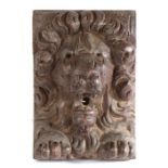 A carved oak lion corbel, circa 1600-20, with a curled mane and open mouthed above paws, 13cm wide,