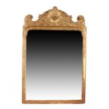 A George I carved giltwood and cut-gesso mirror, circa 1720 The rectangular bevelled plate within a