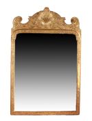 A George I carved giltwood and cut-gesso mirror, circa 1720 The rectangular bevelled plate within a