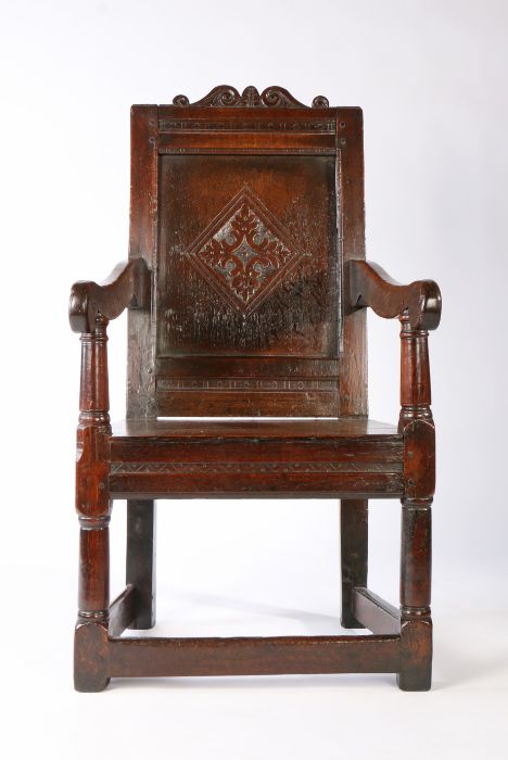 A Charles I joined oak panel-back open armchair, West Country, circa 1640 The back panel centred by