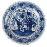 18th Century blue and white Delft dish, the centre with an oversized bird standing on a fence eating