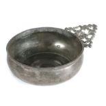 An early 18th century pewter porringer, English, circa 1700-30 Having a booged bowl with bossed