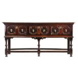 A Charles II joined oak low dresser, circa 1680, the rectangular top above three geometric mitre-