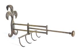 An 18th century iron and brass adjustable fireside cooking hook/spit, the fleur de lys style hook