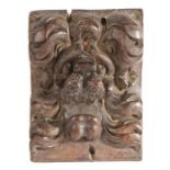 A carved oak lion corbel, circa 1600-20, carved with a curled mane and open mouth, 11cm wide, 14cm