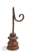 A 19th century iron and wooden  table rush light holder, with tapering nips, square-section stem