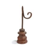 A 19th century iron and wooden  table rush light holder, with tapering nips, square-section stem