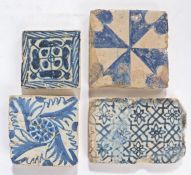 Four  rare 15th/16th century blue and white tiles, Valencia, Spain, the first a  rose tile, 9cm