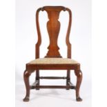 A Queen Anne oak side chair, circa 1710, of low proportions, the arched back above a drop in seat,