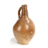 A 17th century stoneware pottery bellarmine jug, the speckled glaze with a mask to the neck, loop