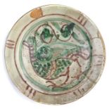 A rare 14th century pottery dish, Spanish, designed with a bird to the centre, possibly a