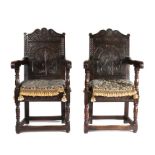 A near pair of Charles I and later armchairs, each with scroll arched and foliate-carved cresting,