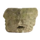 A carved stone head water spout, probably Medieval, circa 1450, worn features, with open mouth and