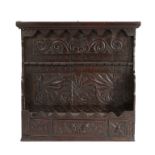 An oak spoon rack, incorporating 17th century elements, the anthemion carved back boards with a