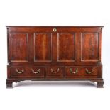 A George III oak mule chest, circa 1780, the hinged top opening to reveal storage space, the