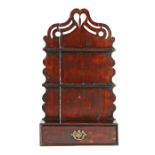 A George III stained pine spoon rack, circa 1790, arched backplate surmounted by a fretwork heart