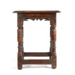 A Charles I oak joined stool, circa 1640, the rectangular top with ovolo-moulded edge, above