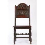 A Charles II oak backstool, Lancashire/Cheshire, circa 1680, the arched cresting foliate carved,