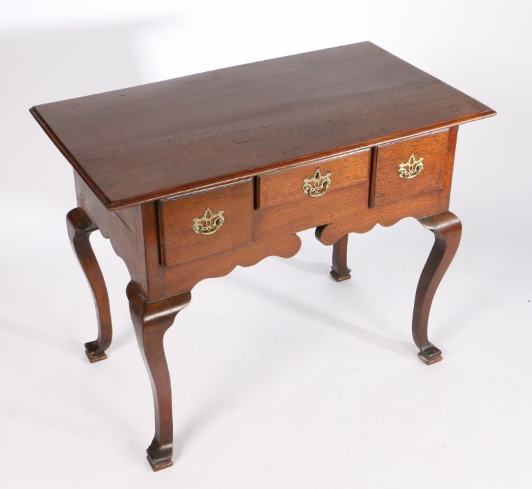 A George III oak lowboy, the rectangular top above three drawers and shaped apron, on cabriole - Image 3 of 3
