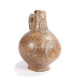A 17th century stoneware pottery bellarmine jug, the speckled glazed body above a bearded mask and
