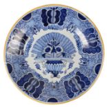 An 18th century blue and white Delft dish, Dutch, an urn filled with blooming flowers to the