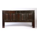 A Henry VIII oak joined and boarded linenfold-carved chest, circa 1530 Having a one-piece boarded