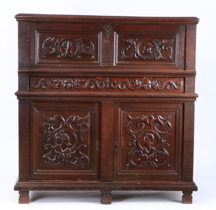 An early 16th century oak cupboard, French, the rectangular top above a hinged fall carved with - Image 2 of 2