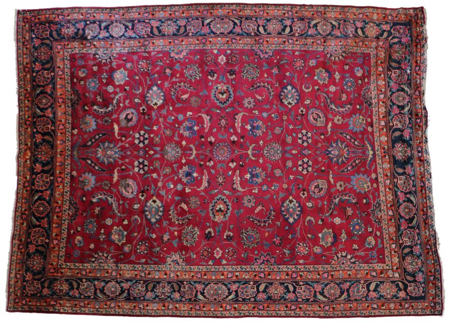 A fine North-East Persia Meshed rug, the burgundy field with delicate floral tendrils issuing bold