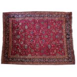 A fine North-East Persia Meshed rug, the burgundy field with delicate floral tendrils issuing bold