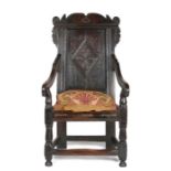 Charles II joined oak panel-back open armchair, Yorkshire, circa 1670, the back panel carved with