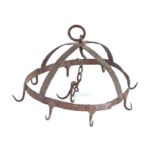 A wrought iron game hanger, designed as a crown with eight hooks, centred by a chain with a further