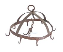A wrought iron game hanger, designed as a crown with eight hooks, centred by a chain with a further