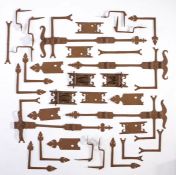 A collection of 18th/19th century cabinet ironmonger: mainly hinges, with various decorative leaf