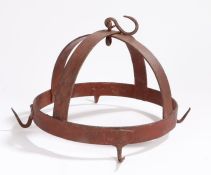 A wrought iron game hanger, of crown form, the circular frame with four hooks, red paint, 26cm wide