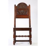 A Charles II oak backstool, Lancashire/Cheshire, circa 1680, the arched cresting and back panel