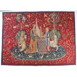 A Medieval style 'Unicorn' tapestry, centred by two ladies, one playing a harp, flanked by a