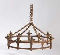 A Gothic-Revival wrought-iron chandelier, of crown form, hung on four chains, the six candle
