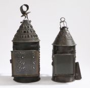 Two 19th century tin lanterns, each with a conical pieced top with hanging loop, the drum with '