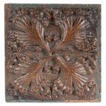 A Henry VII oak ceiling boss, circa 1500, designed as a leafy-quatrefoil, later backing board,