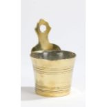 An 18th century brass holy water stoup, with shaped backplate pierced for hanging, the circular-