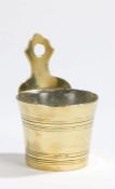 An 18th century brass holy water stoup, with shaped backplate pierced for hanging, the circular-