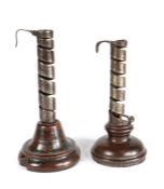 TWO 18TH CENTURY WROUGHT IRON SPIRAL EJECTOR CANDLESTICKS, FRENCH Each with a turned fruitwood base