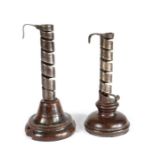 TWO 18TH CENTURY WROUGHT IRON SPIRAL EJECTOR CANDLESTICKS, FRENCH Each with a turned fruitwood base