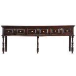 A good Charles II oak low dresser, circa 1680, the long rectangular top above three paired
