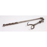An 18th century steel 'toasting fork', with two tines, attached by chains to the twist handle with