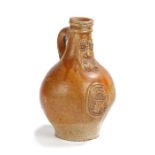 A 17th century stoneware pottery bellarmine jug, the brown glazed body with a bearded mask above a