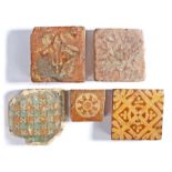 A collection of Medieval tiles, to include a small example with central round slip and eye, 7.5cm