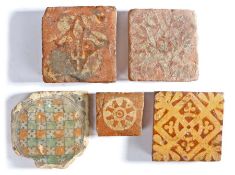 A collection of Medieval tiles, to include a small example with central round slip and eye, 7.5cm