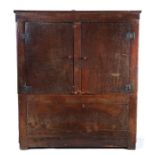 An unusual boarded oak press cupboard, possibly Welsh, circa 1700, the simple cornice above two